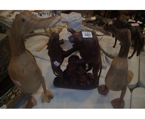 Black forest style carved figurines of a lion fighting a wolf and two shelf ducks. This lot is not available for in-house P&a