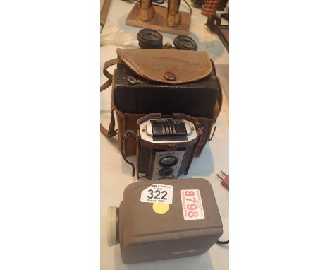 Two pairs of vintage binoculars, a vintage Brownie Reflex and a Minolta Mini 35 projector. This lot is not available for in-h