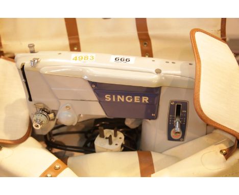 Cased electric Singer sewing machine. This lot is not available for in-house P&P.Condition Report: All electrical items in th