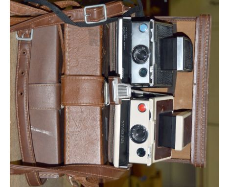 6 Polaroid SX-70 Folding SLR Cameras in 3 Outfit Cases. (condition 5F & 6F). Sold "As Seen" but some appear working (used fil