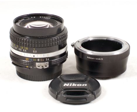 Nikon 20mm AI-s Manual Focus f3.5 Lens. #213012 with caps (condition 5F). Plus a Nikon-M4/3 lens adapter (condition 5F).