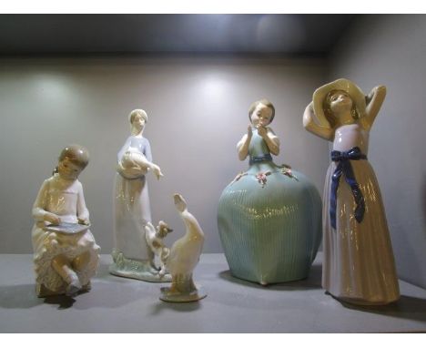 A group of five Lladro and Nao porcelain figurines to include one of a girl holding a goose in her arms and a dog by her feet