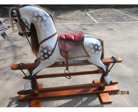 A Stevenson Brothers 1994 dapple painted carved wood rocking horse 