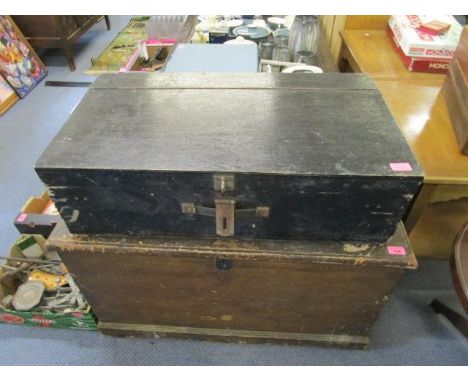 A Victorian stained pine trunk with iron carrying handles and a black painted wooden chest 