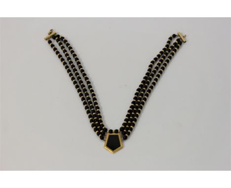 A black hardstone bead necklace, featuring a central panel of black hardstone, length approx. 38cm. IMPORTANT: Online viewing