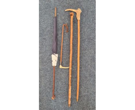 Two folk art walking sticks, one with carved head of boxer dog, horse riding crop, and a birch handled parasol. IMPORTANT: On
