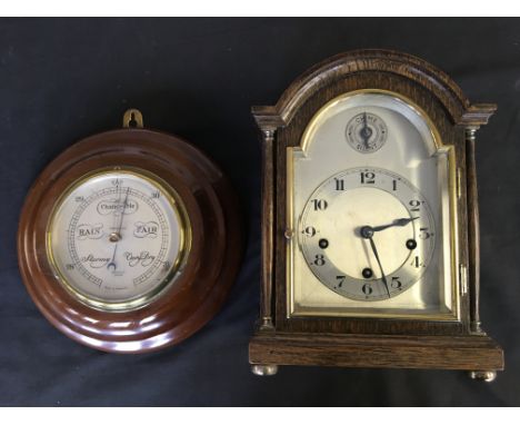 An oak mantel clock with chime and silent dial, together with a Harrods Ltd London wall hanging round barometer.IMPORTANT: On