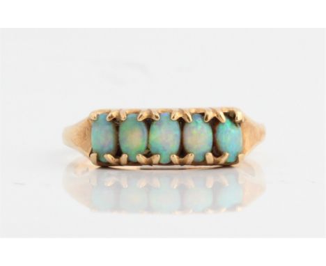 A five stone opal ring, set with five oval opal cabochons, stamped 375, ring size R, approx. weight 2.8g. IMPORTANT: Online v