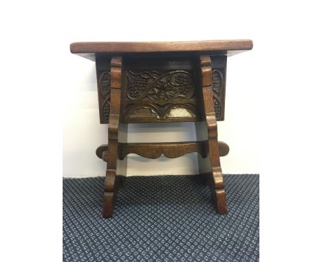 An oak reproduction 16th century style stool with carved grape vines panel. IMPORTANT: Online viewing and bidding only. Colle