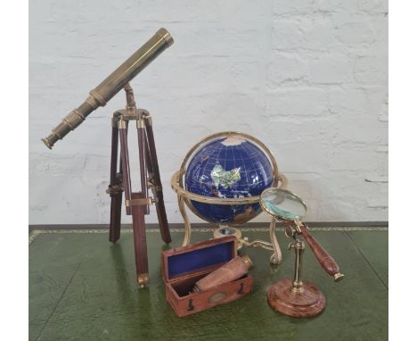 A small telescope, a small gemstone style terrestrial globe, a magnifying glass in stand and a Nauticalia extending telescope