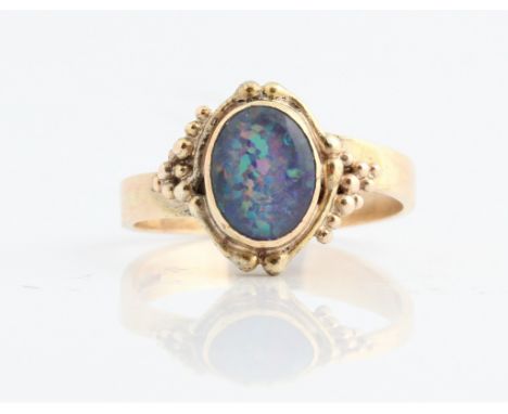 A hallmarked 9ct yellow gold synthetic opal doublet ring, ring size P½, approx. weight 3.7g. IMPORTANT: Online viewing and bi