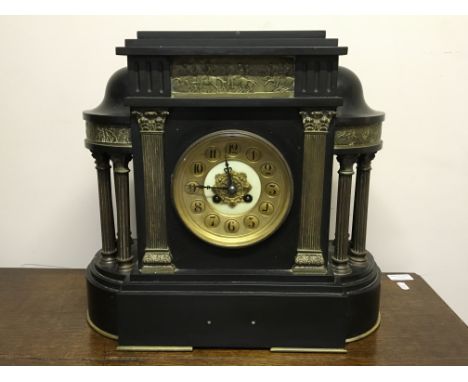 A black slate classical temple style mantel clock with brass columns and battle scene frieze, height 38cm.IMPORTANT: Online v