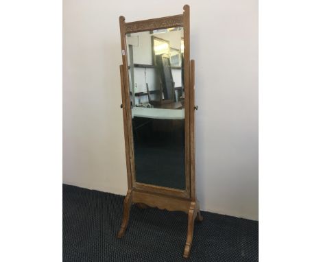 A limed oak, carved to top with English rose floor standing cheval mirror. IMPORTANT: Online viewing and bidding only. Collec