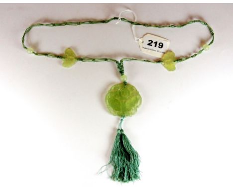 A 1920s / 1930s Chinese carved nephrite jade butterfly amulet on a decorative silk with additional jade beads