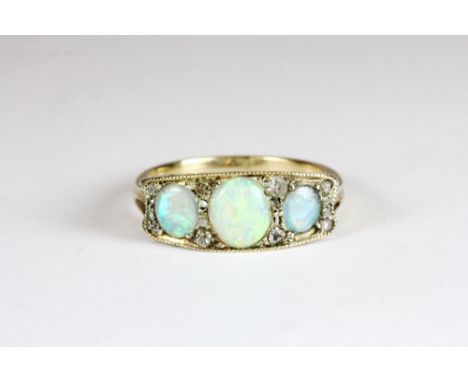 An antique yellow metal (tested min 9ct gold) opal and diamond ring (M)