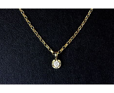 An 18ct yellow gold diamond solitaire pendant and 18ct gold chain