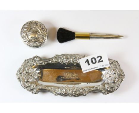 An ornate hallmarked silver tray, hallmarked silver makeup brush and hallmarked silver patch box.