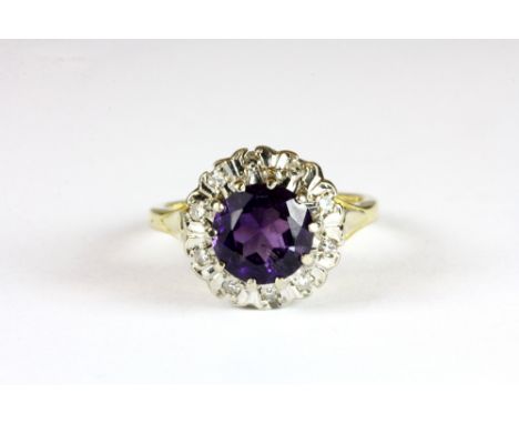 An 18ct yellow gold amethyst and diamond cluster ring (M)