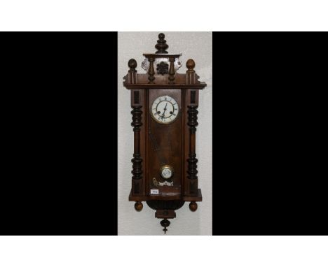 A Late 19thC Vienna Wall Clock white enamel chapter dial with Roman numerals, spring driven movement with pendulum, Typical p