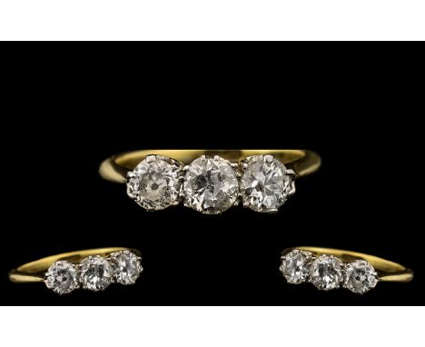 18ct Yellow Gold Three Stone Diamond Set Ring.  The three diamonds of excellent colour and sparkle.  Black specs to two diamo