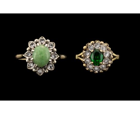 A 9ct Gold Ring set with a central cabochon jade coloured stone surrounded by round cut diamonds. Fully hallmarked. Ring size