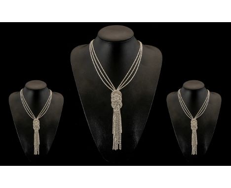 White Crystal Long Circle and Tassel Necklace, the full length of the necklace comprising three strands of white crystals to 