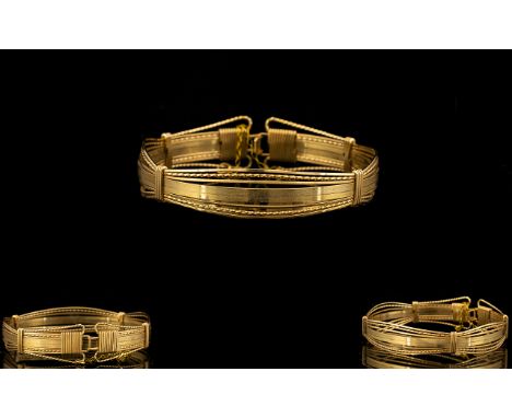 Antique Yellow Metal Bangle. Yellow metal bangle, figural form, with safety chain, weight 11 grams, please see accompanying i