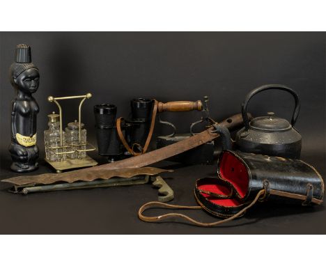 A Box of Interesting Oddments and Curios to include a short sword, a decanter marked Vudu, iron kettle, binoculars etc