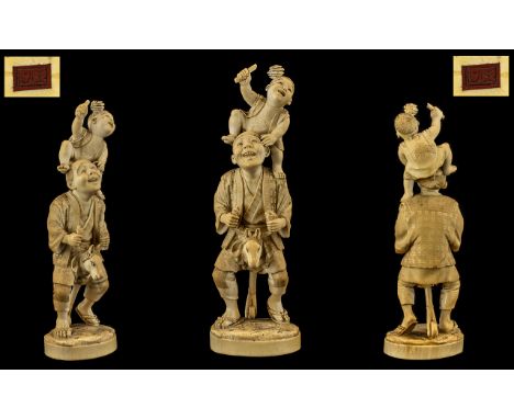 Japanese Tokyo School Signed Hand Carved Ivory Figure - Meiji period 1864 - 1912. Depicts a father and son in playful scene. 