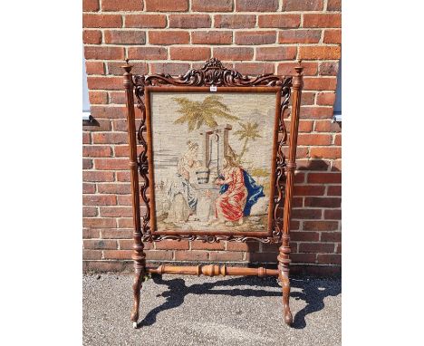 A large Victorian carved walnut and tapestry panelled fire screen, 132.5cm high x 85.5cm wide. 