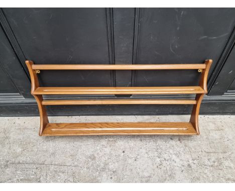 A mid-century Ercol elm hanging plate rack, 96.5cm wide. 