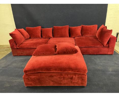 A large modern sofa in red upholstery, with a matching stool. H.60 W.330 in three parts D.120.cm stool is H.50 D.120.cm squar