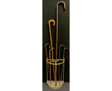 A Victorian tubular brass demi-lune stick stand, four division top, cast iron base, 64cm high, 39cm wide, 20cm deep;  George 