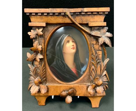 A 19th century Berlin oval portrait plaque, Madonna, the oak frame carved with leaves, 28cm high, 23cm wide, late 19th centur