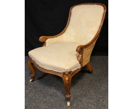 An early Victorian mahogany nursing chair, arched back, scroll arms, stuffed-over seat, cabriole legs, ceramic casters, c,186