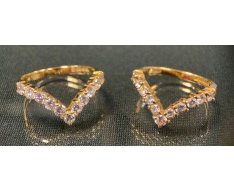 A pair of diamond V rings, each inset with eleven round brilliant cut diamonds, total estimated diamond weight approx 1.1ct, 