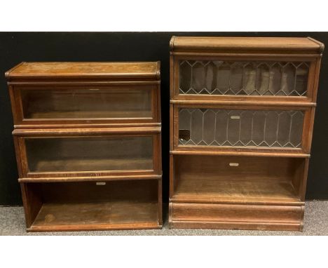 A Globe Wernicke oak three tier stacking bookcase. the top two tiers with leaded glass doors, 121cm high, 87cm wide, 28cm dee