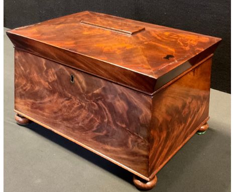 A large Victorian mahogany sarcophagus tea caddy, the interior with four lidded compartments,  two mixing bowl apertures, bun