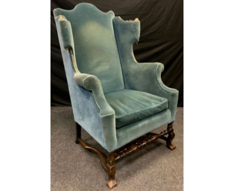 A good 19th century wing back chair, turned stretchers, Spanish feet, upholstered in light blue, c.1880 