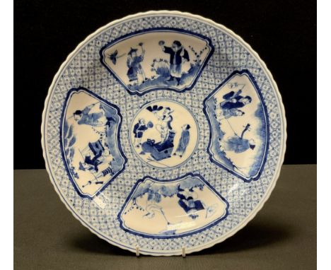 A Chinese blue and white plate, Kangxi (1662-1722) mark and probably period, decorated with five panels of Elders and Immorta