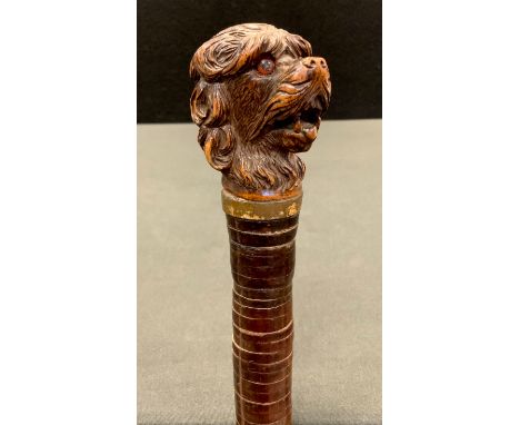 A 19th century Black Forest walking stick, the handle carved with a dog's head, leather shaft, 87cm long, c.1890 