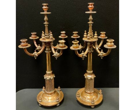 A pair of Gothic Revival brass five-light four-branch candlesticks,  in the manner of Augustus Welby Northmore Pugin (1812 - 