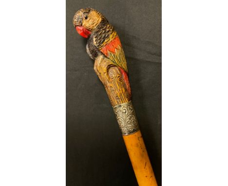 A 19th century Black Forest walking stick, the haft carved with parrot, silver embossed collar, 97cm long 