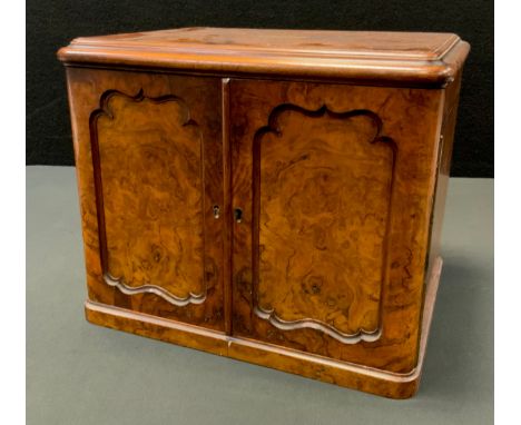 A Victorian walnut dressing cabinet, hinged cover, the interior fitted with various plated bottles, scent flask and pen knife