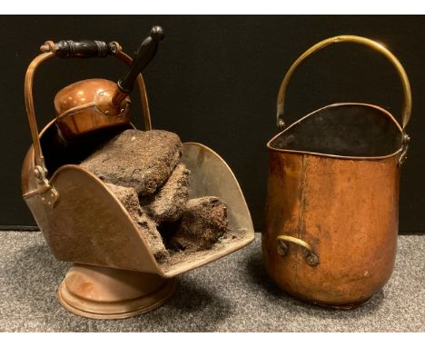 A Victorian copper helmet shaped coal/log bucket and shovel, tapering arched opening, circular foot, swing handle, 48cm high,