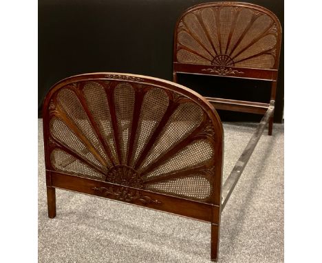 An early 20th century mahogany framed bergere caned single bed, Fan shaped head and foot boards, 119cm high, 200cm long, 99cm