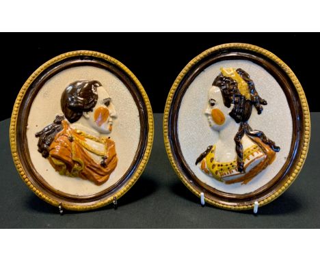 A pair of 19th century oval pearlware portrait plaques,  modelled in high relief with profile portraits of Louis XVI and Mari