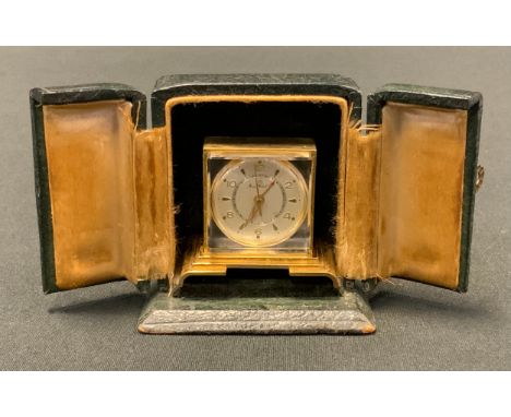 A miniature Home Watch Company Swiss travel clock, as a mantel clock, 3.5cm high, cased 