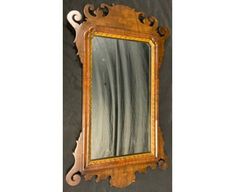 A 19th century mahogany Vauxhall mirror, pierced scroll  frame, trimmed in gilt, 69cm x 42cm overall 