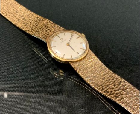 Omega - a 9ct gold bracelet wristwatch, silvered dial, block baton markers, date aperture, minute track, centre seconds, Cal 